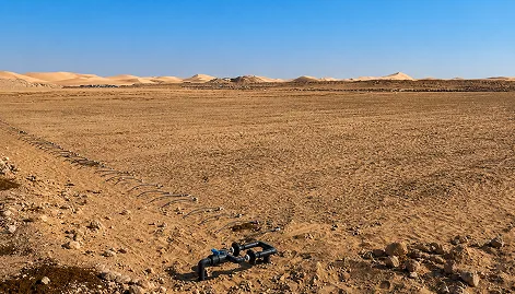 ChatGPT Image Sep 4, 2026, 12_42_46 AM (5) 1 Irrigation pipes and drip lines installed across undeveloped desert farmland.